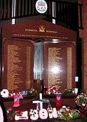 Hillsborough Memorial, which is engraved with the names of the 96 people who died in the Hillsborough disaster. Flowers are below the memorial.