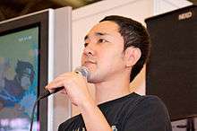 Hiroshi Matsuyama holding a microphone