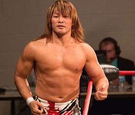 Hiroshi Tanahashi, a Japanese man with long brown hair, at a professional wrestling event
