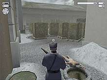 A man wielding gun looks across the unconscious, naked body of a guard in an outside storage facility.