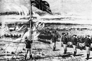 The Union Jack is raised atop a hill by a man in military uniform. Officers and men in the same uniform stand to attention. Covered wagons and makeshift buildings can be seen in the background.