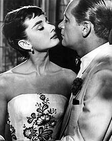 A still of Hepburn on the left opposite William Holden on the right in the film Sabrina.