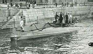 Submarine surfaced in a Japanese harbour.