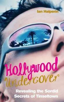 Cover has a close up of a man's face, with palm trees and a sunset reflected in the lens of his dark glasses