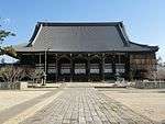 Large wooden building with tile roof.
