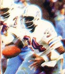 A picture of Earl Campbell rushing the ball.