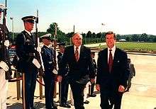 Photograph of Australian Prime Minister John Howard escorted by US Secretary of Defense William Cohen through an armed forces honor cordon into the Pentagon, June 1997