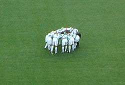 Picture of the Celtic players doing their customary pre-match "huddle"