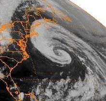 A satellite image of a loosely organized hurricane offshore of the Eastern United States
