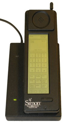 Photograph of the Simon Personal Communicator shown in its charging base