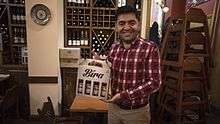 İbrahim Doğuş at Troia restaurant with a sample of his Bira beer.