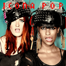 The two members of the group Icona Pop are photographed with their mouths open. They are both wearing large helmets which have been decorated with various items such as metal studs and feathers