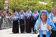 Six women in headdresses resembling nuns