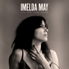Photo of May with a sepia-coloured tint, with "Imelda May" and "Life Love Flesh Blood" superimposed above