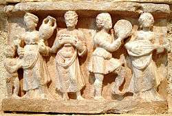 stone relief carving Wine-drinking and music from Chakhil-i-Ghoundi stupa, Hadda, Afghanistan
