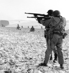 Landscape shot of soldiers moving across a desolate landscape