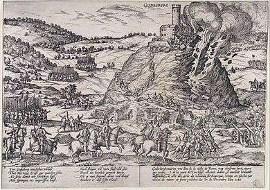 A castle stands at the top of a steep hill, and its walls are being blown away in explosion and fire. The fortress is surrounded by mounted and foot soldiers and several units of mounted soldiers are racing up the hill toward the castle on its peak. Frans Hogenberg, a Dutch engraver, and artist of the 16th century, was living in the Electorate of Cologne during the war, and engraved this picture of the destruction of the Godesburg (fortress).