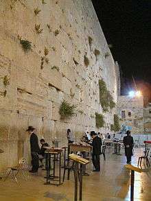 Jews praying at the Western Wall in the evening