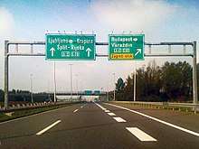 Directional traffic signs placed on a gantry