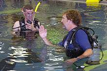 J.R. Salzman learning to dive with the help of an instructor in 2007