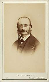middle-aged white man with receding hair, pince-nez, moustache and side-whiskers