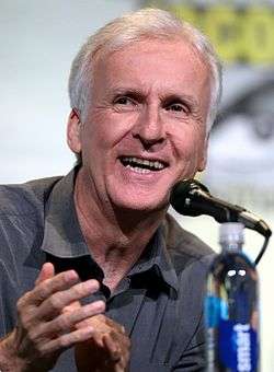 James Cameron, a man in his late fifties with white hair, smiling