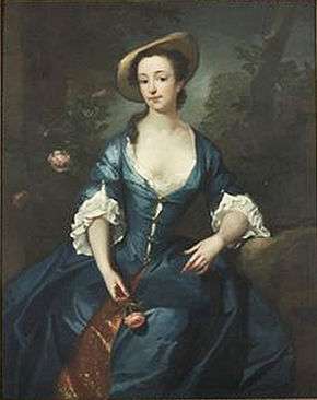 Portrait of a girl, seated, wearing a blue dress and holding a rose.