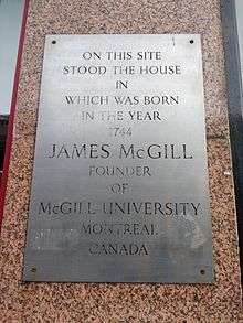 Wall plaque. Text reads: "On this site stood the house in which was born in the year 1764 James McGill founder of McGill University Montreal Canada".