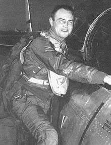Hagerstrom posing in his flight suit while climbing into the cockpit