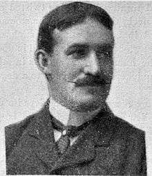 James T Sutherland dressed in suit and tie, with signature moustache
