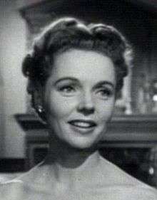 Black-and-white photo of a smiling Jane Wyatt