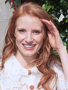 A photograph of Chastain smiling at the 2013 Toronto Film Festival