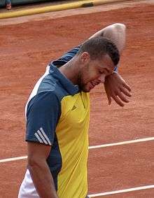 Tsonga wiping his face with his wristband.
