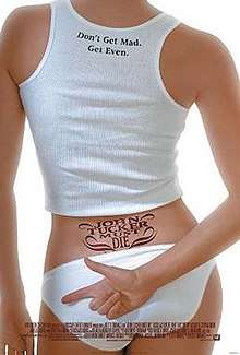 A woman in a white tank top and bikini bottoms, with a lower back tattoo, which reads "John Tucker Must Die". Her right hand is behind her back, index finger pointing and others curled as if making a gun gesture.