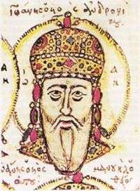 Head of an elderly white-bearded man, wearing a golden jewel-encrusted domed crown and surrounded by a halo.