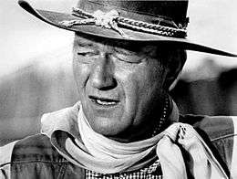 Black-and-white image of John Wayne looking to the left.