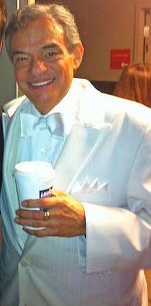A man wearing a white tuxedo.