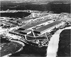 Oblique aerial view of an enormous U-shaped building
