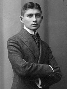 Black-and-white photograph of Kafka as a young man with dark hair in a formal suit