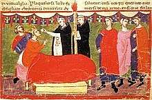 A crowned man lying in bed takes the Eucharist from two priest