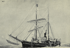 Two-masted sail-and-steam ship, with pennant flying from topmast, sails furled, lying stationary in a frozen sea