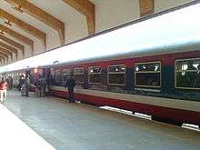 Long passenger train at a large station