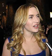 Kate Winslet speaks into a microphone.