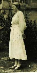Photograph of Ka Cox standing in a dress, date unknown