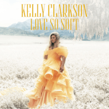 A woman wearing a yellow dress standing on a white field; top-center, the artist "Kelly Clarkson" and the title "Love So Soft" are printed in yellow sans-serif typefaces