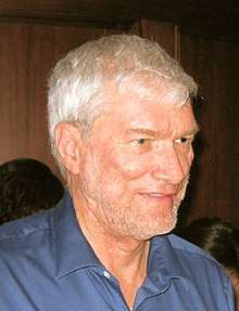 Ken Ham's photo, showing a man with gray hair and a thin, gray beard
