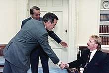 President George H.W. Bush and Sen. Bob Dole meet with Kevin Saunders.