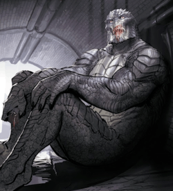 A man with crocodilian-like features sits against a wall.