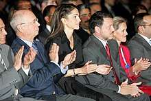 Abdullah, Rania and two other people applauding in an audience