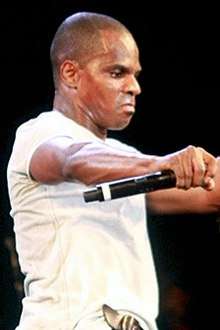 Kirk Franklin, holding a microphone